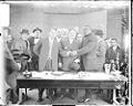 Boxer Jack Johnson on the left shaking hands with another gentleman.