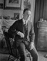 Irving Kaufman, singer and Vaudeville performer, seated on a chair.